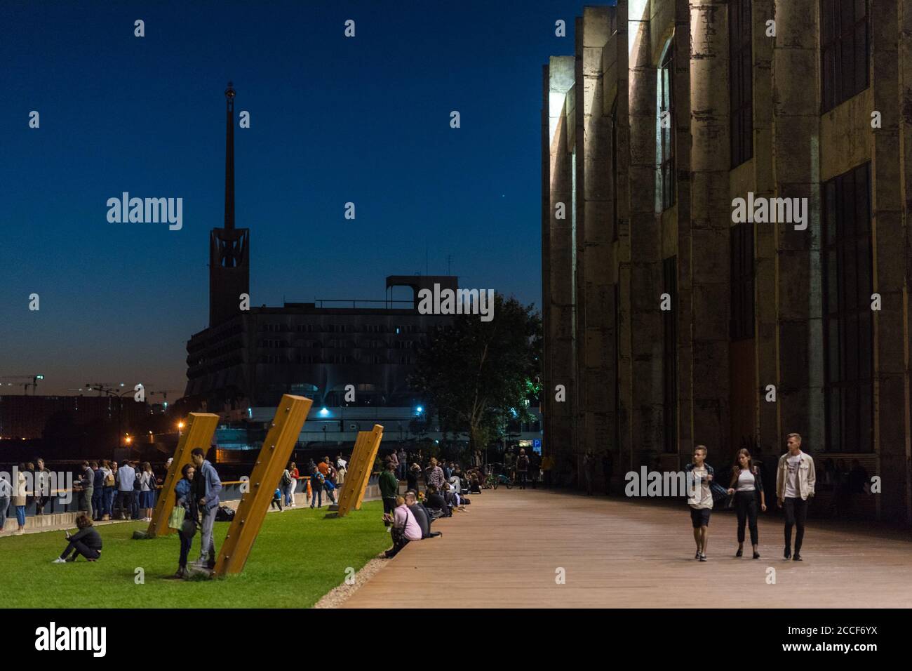 Saint Petersburg, Russia - August 18, 2020: a crowd hangs out at the seafront of Sevkabel Port at night. Stock Photo