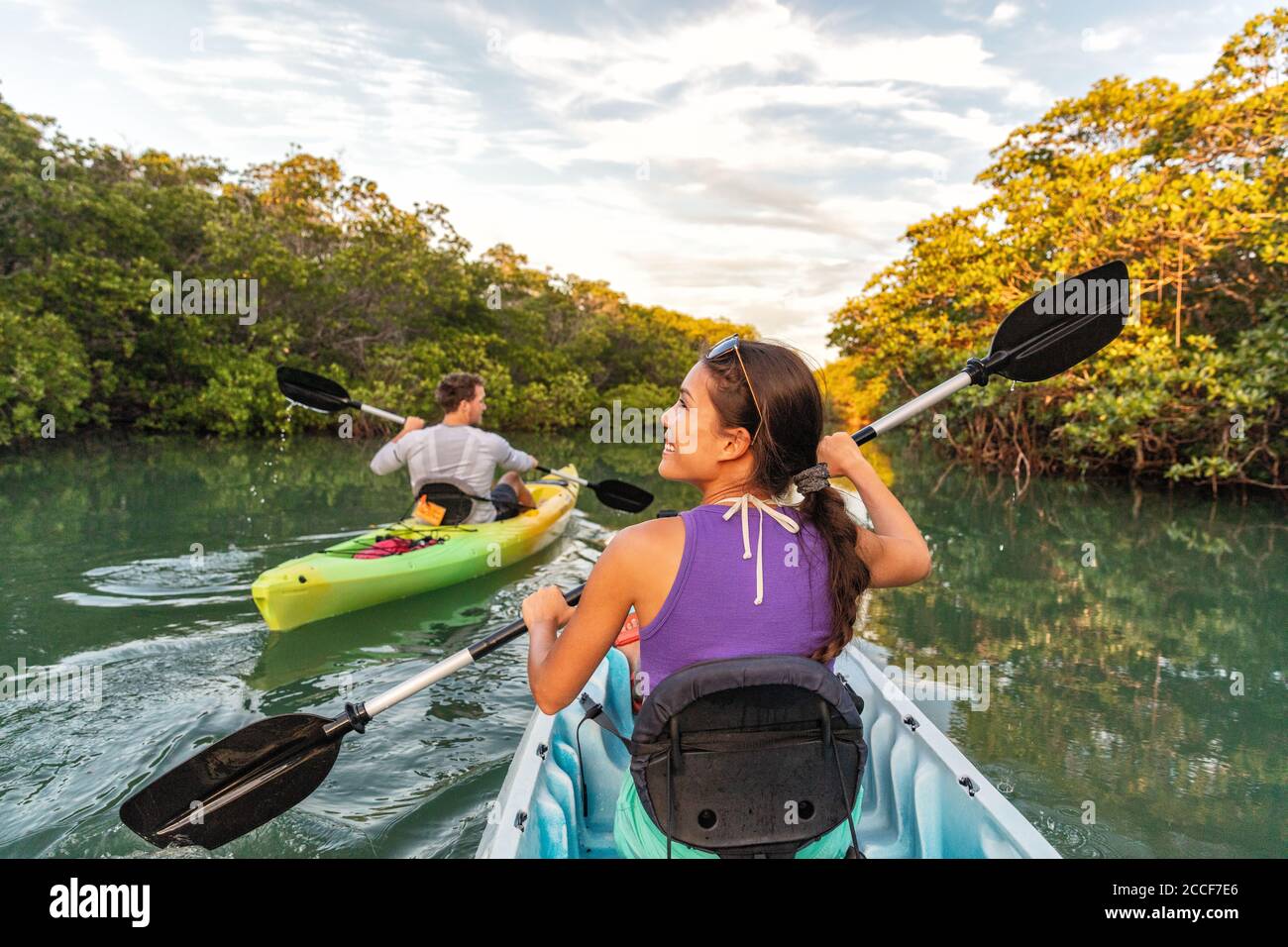 Couple kayaking together in mangrove river of the Keys, Florida, USA. Tourists kayakers touring the river of Islamorada Stock Photo