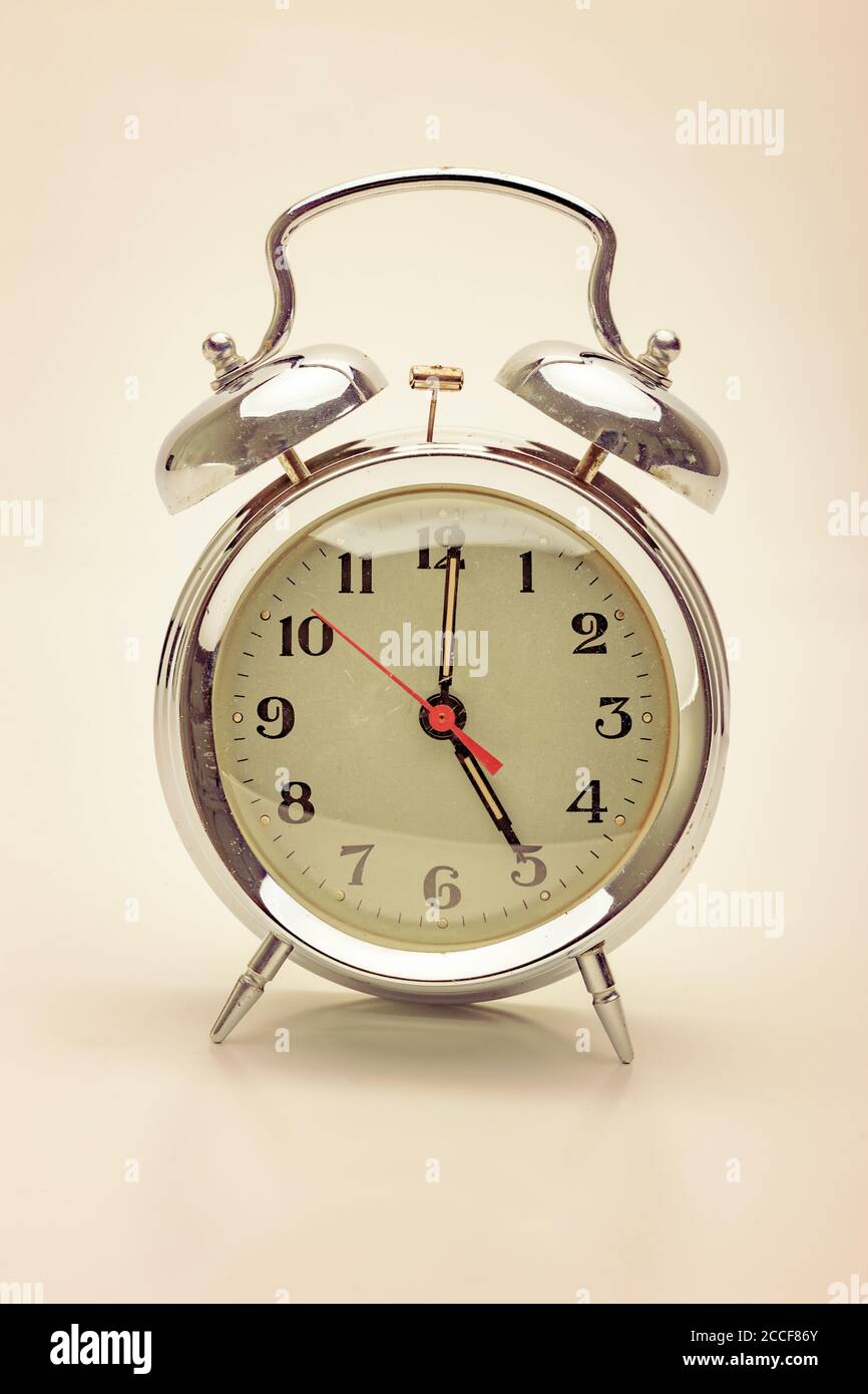 Old nostalgic alarm clock at five oclock hires stock photography and
