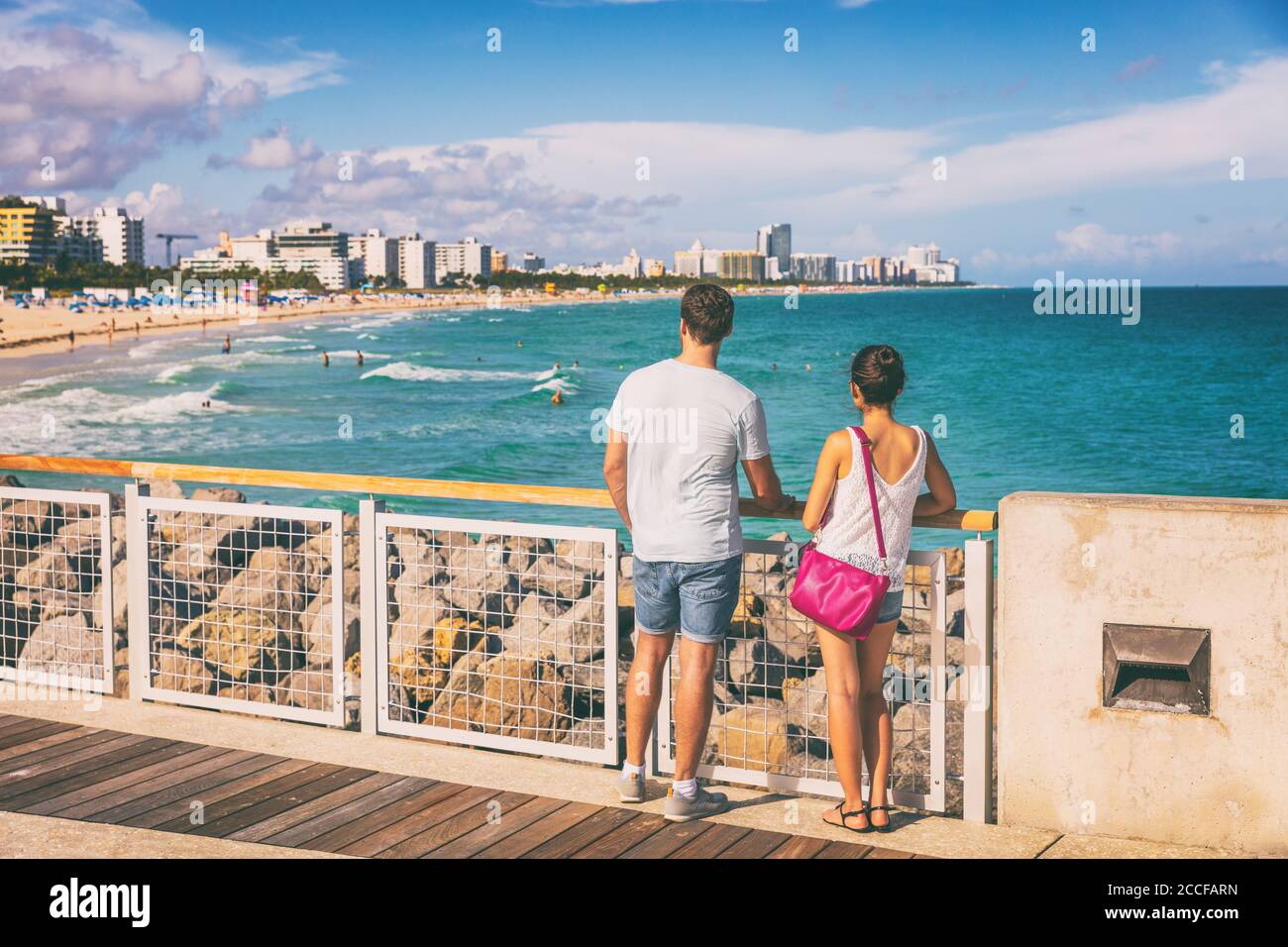 Miami beach people lifestyle young tourists couple walking in South Beach, Miami, Florida. USA travel Stock Photo
