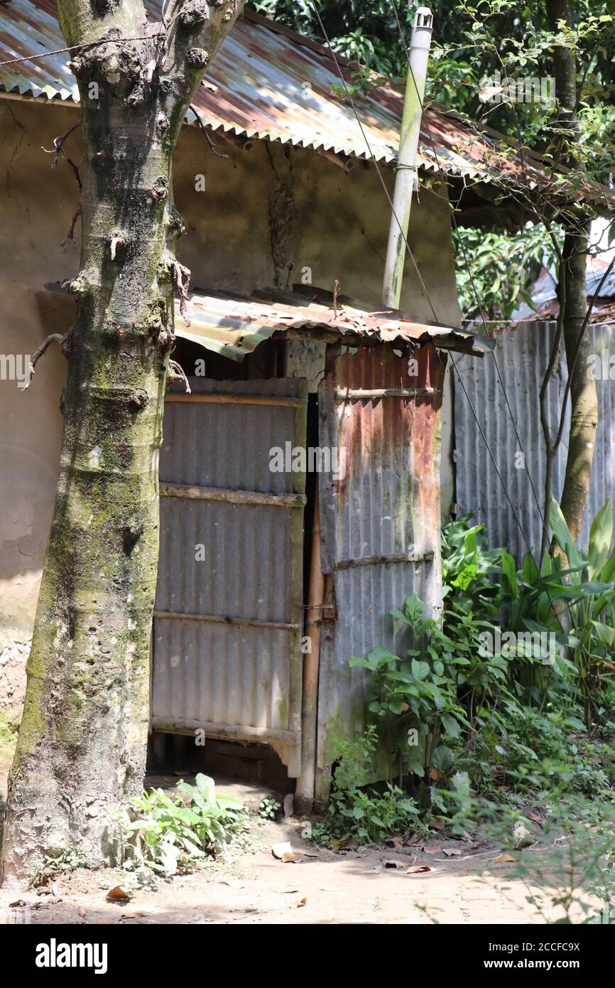 Image of a tin shed unhygienic village latrine attached to a house used ...
