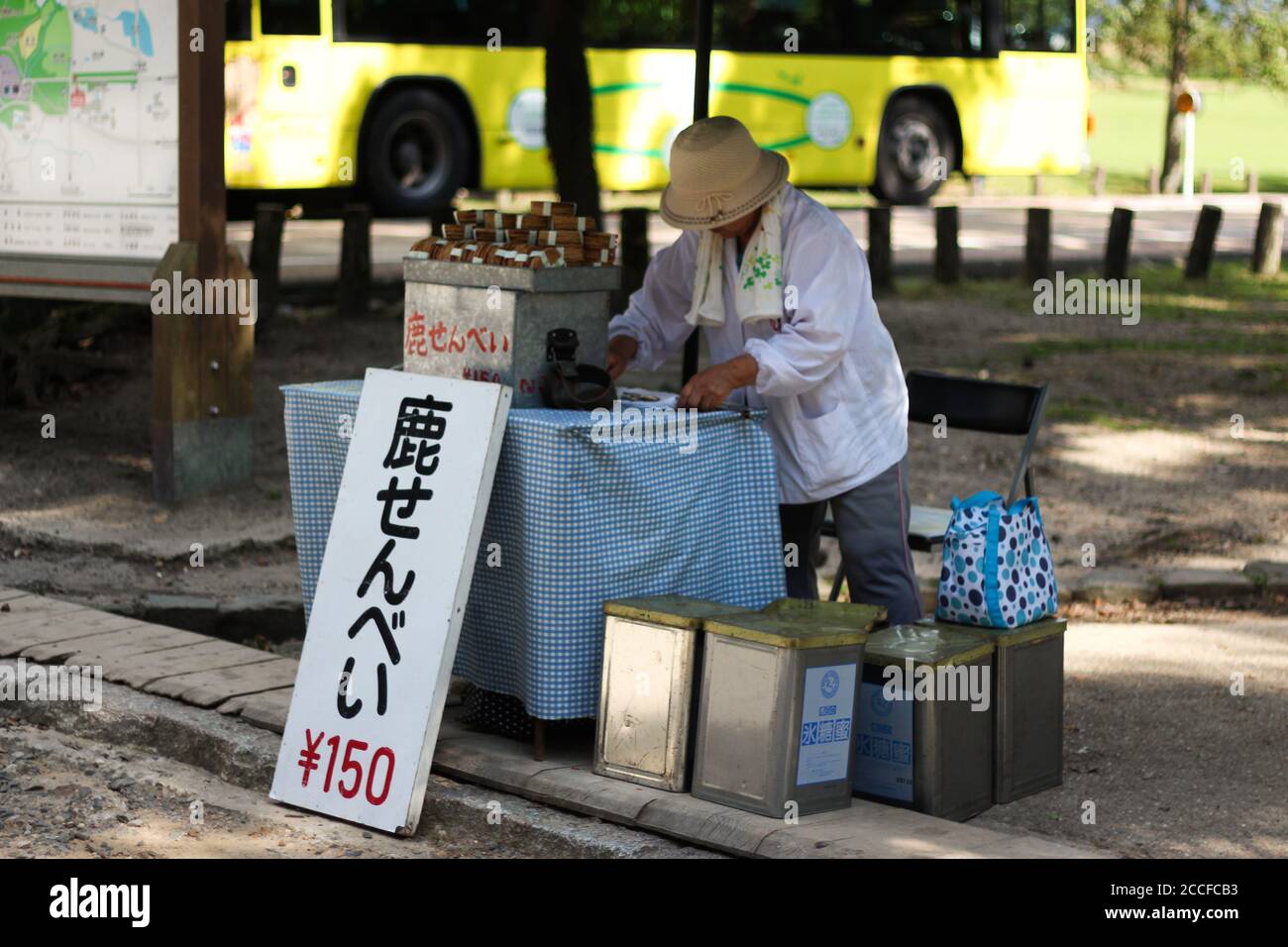 Nara Japan, 3 July 2016: Woman selling 'shika senbei' deer crackers at Nara Deer Park. The sign reads 'deer senbei 150 yen' Stock Photo