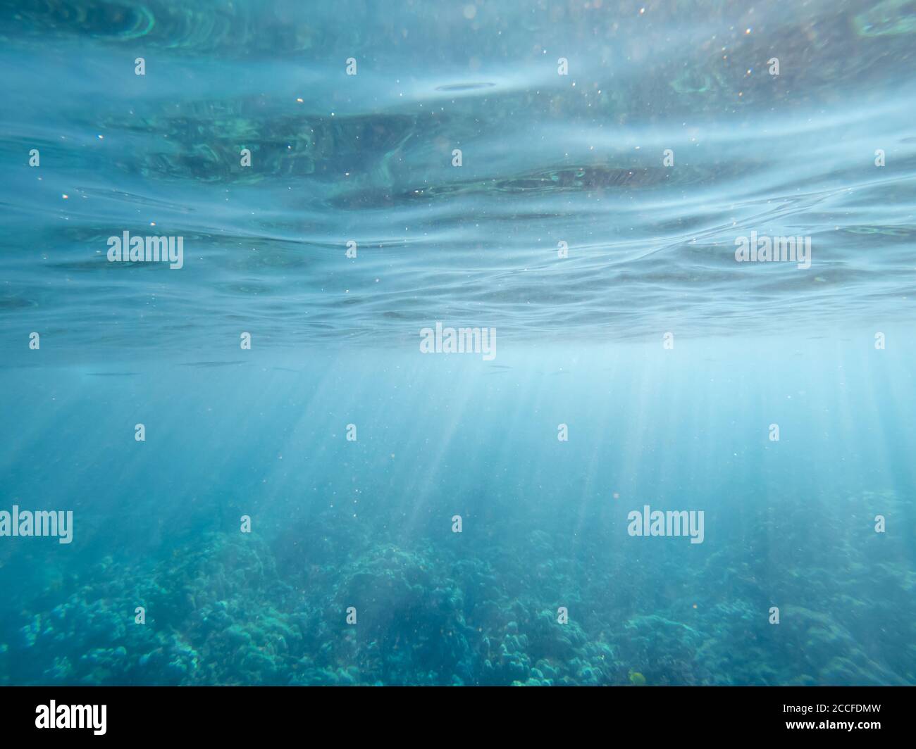 Underwater rays of light with ripples on surface Stock Photo