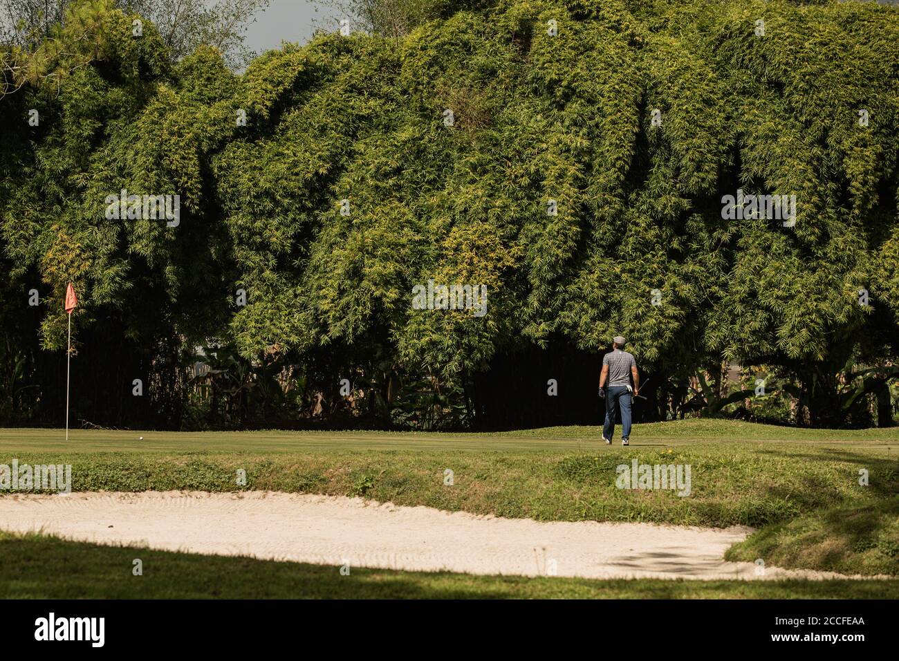 medium shot. Professional golfer goes to do a kick. High quality photo Stock Photo