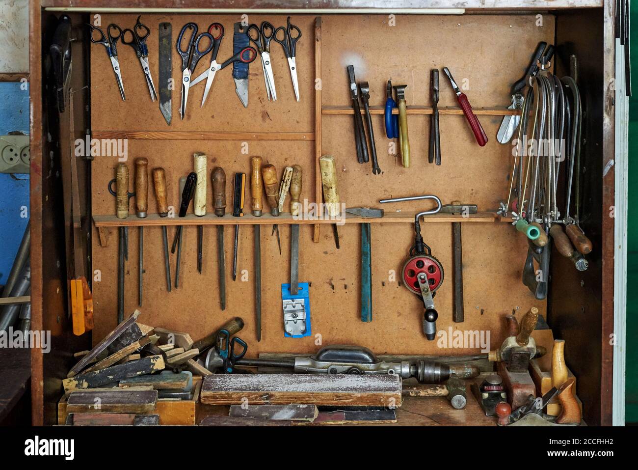 Old carpentry work tools on a wooden wall. Stock Photo