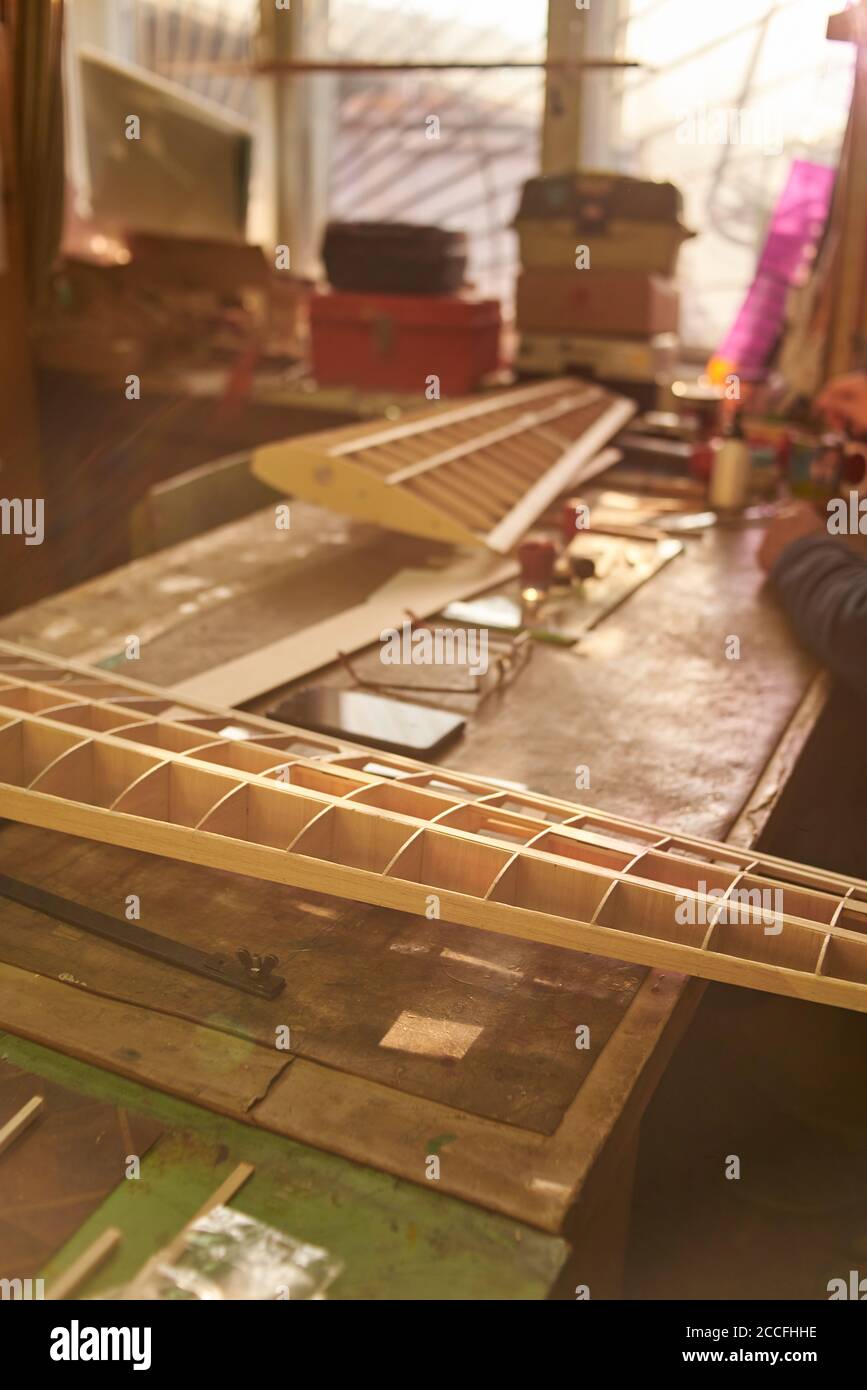 The wooden wing of a radiocontrolled aircraft on the desktop in the