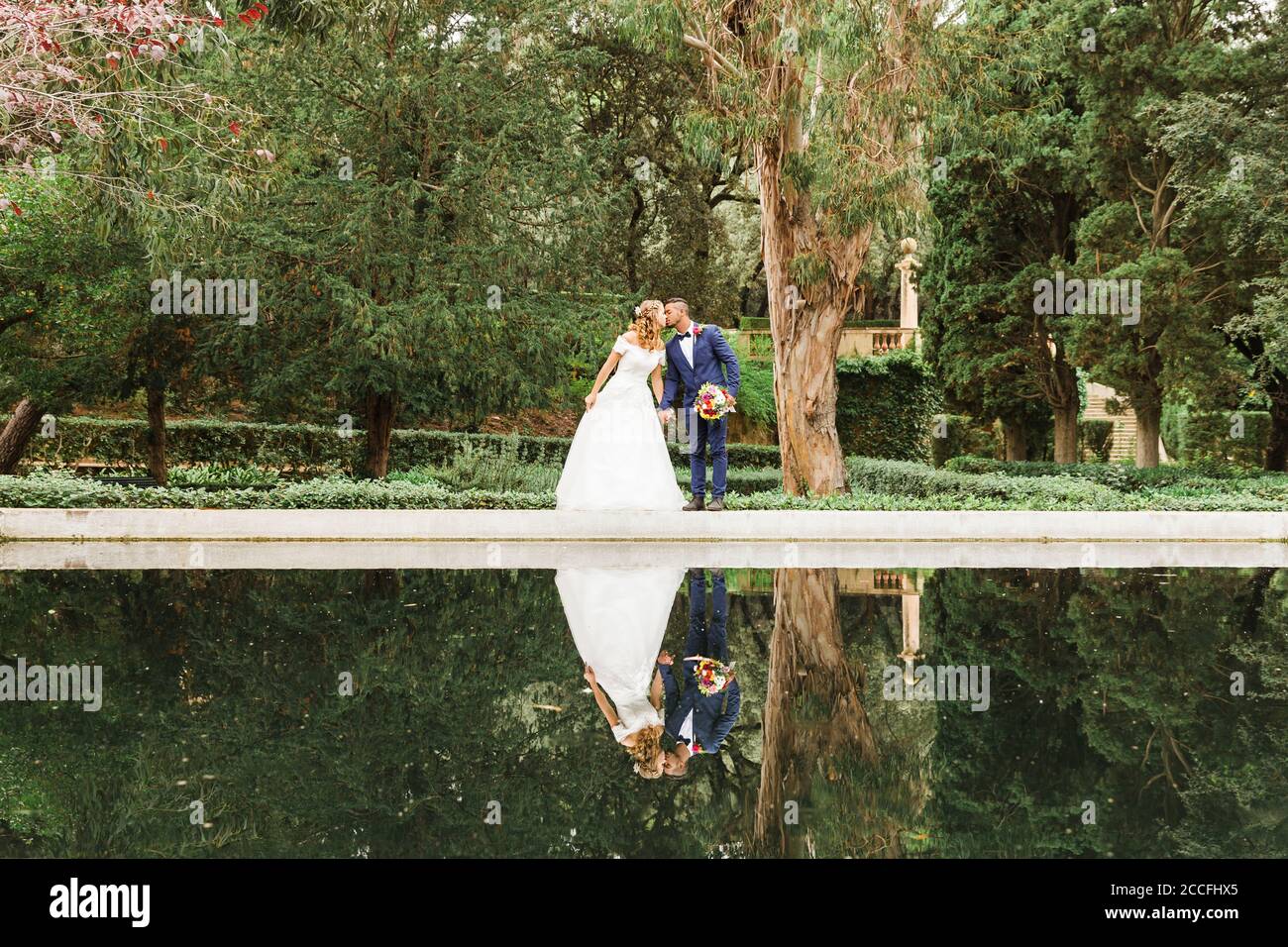 Wedding, newlyweds, young adults, diversity, love, park, reflection Stock Photo
