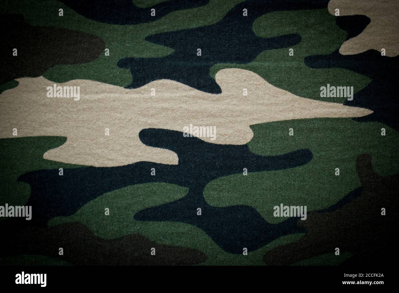 Military camouflage cloth, fabric background with vignette Stock Photo