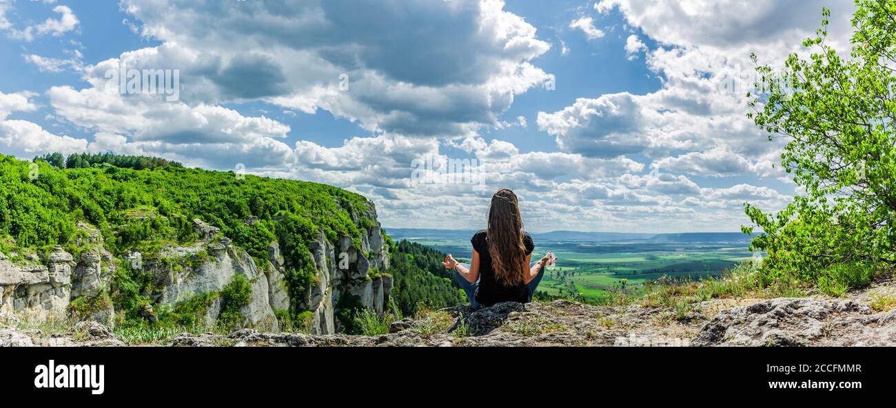 Woman doing yoga on the cliffs of Madar, Bulgaria Stock Photo