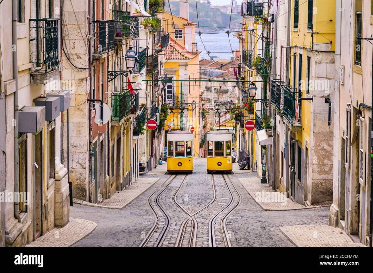 Historic yellow funicular in a steep street in Lisboa, Portugal Stock Photo