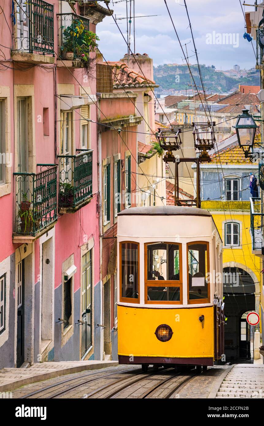 Historic yellow funicular in a steep street in Lisbon, Portugal Stock Photo