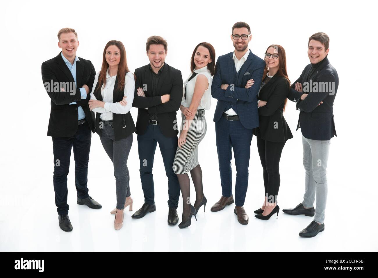Happy business team with arms crossed over white background Stock Photo ...