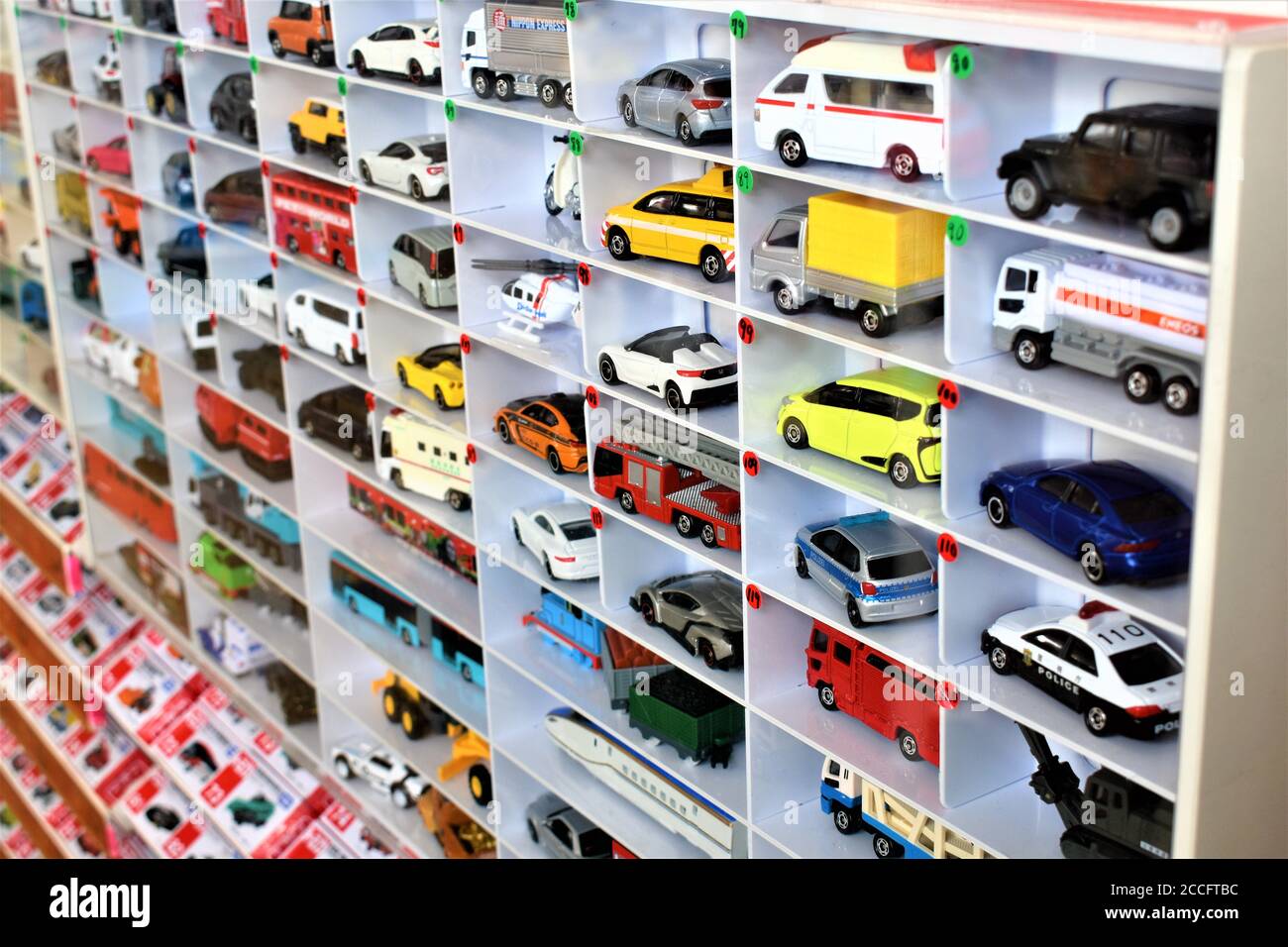 Diecast model cars are displayed for sale on a shelf in a toy store Stock Photo