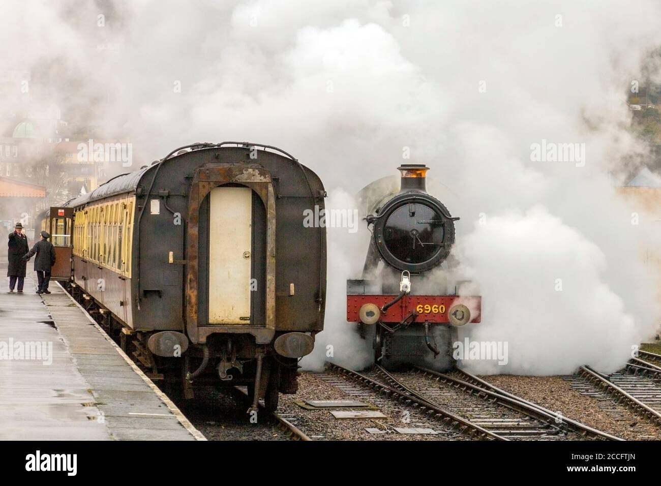 Ex-GWR steam loco 6960 'Raveningham Hall' makes dramatic departure from the engine shed at Minehead, West Somerset Railway Spring Gala, England, UK Stock Photo
