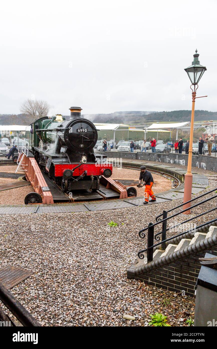 Ex-GWR steam loco 6990 'Witherslack Hall' on the turntable at Minehead station, West Somerset Railway Spring Gala, England, UK Stock Photo