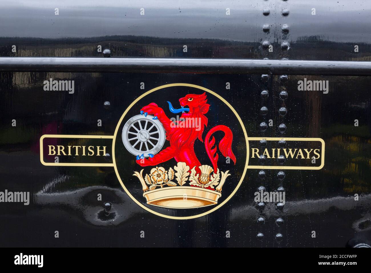 An early British Railways crest on Ex-GWR 0-6-0 pannier tank steam loco 7714  at Minehead station, West Somerset Railway Spring Gala, England, UK Stock Photo