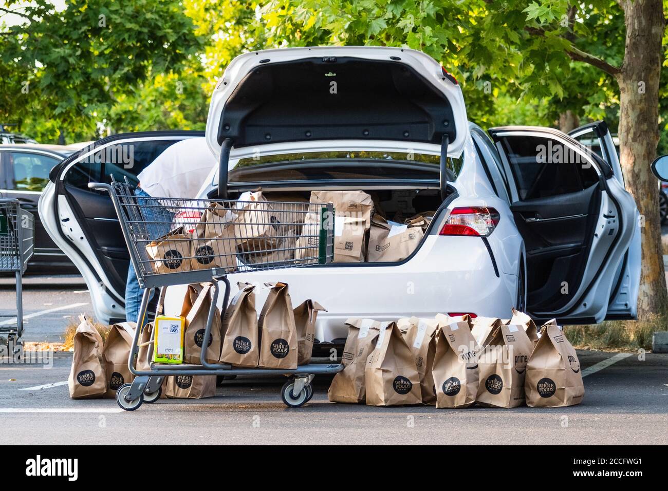 August 1, 2020 Cupertino / CA / USA - Vehicle loaded by an Amazon Prime delivery person with groceries ordered online from Whole Foods Market; The cor Stock Photo