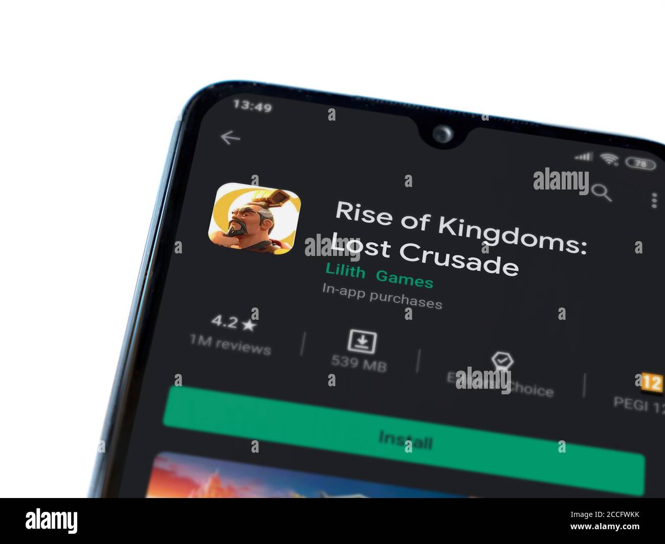 Lod, Israel - July 8, 2020: Rise of Kingdoms app play store page on the display of a black mobile smartphone isolated on white background. Top view fl Stock Photo