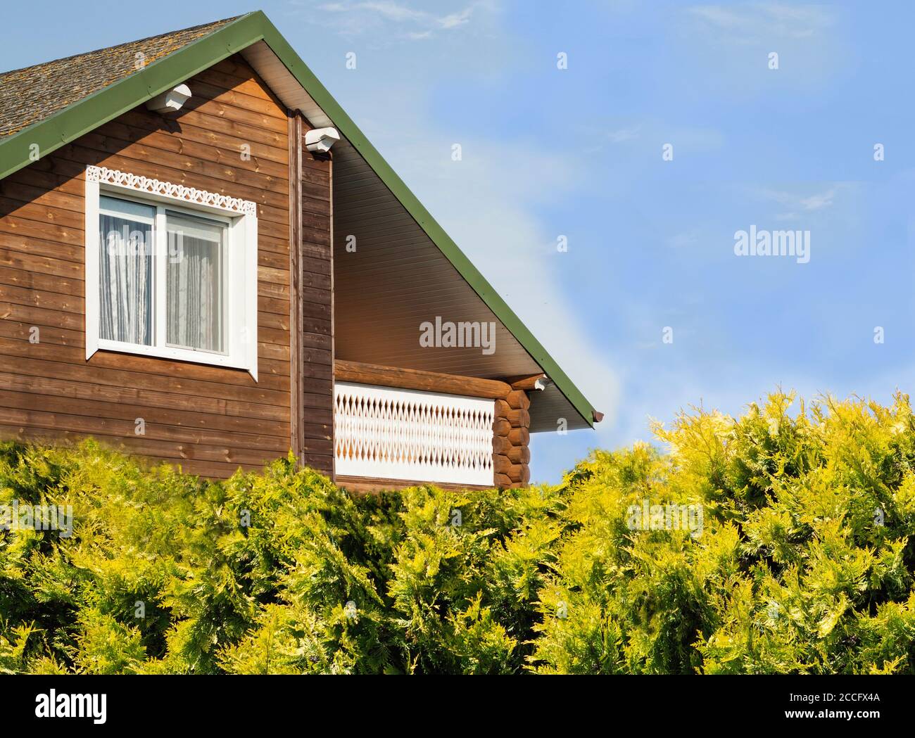 wooden house, green grass and a blue sky Stock Photo
