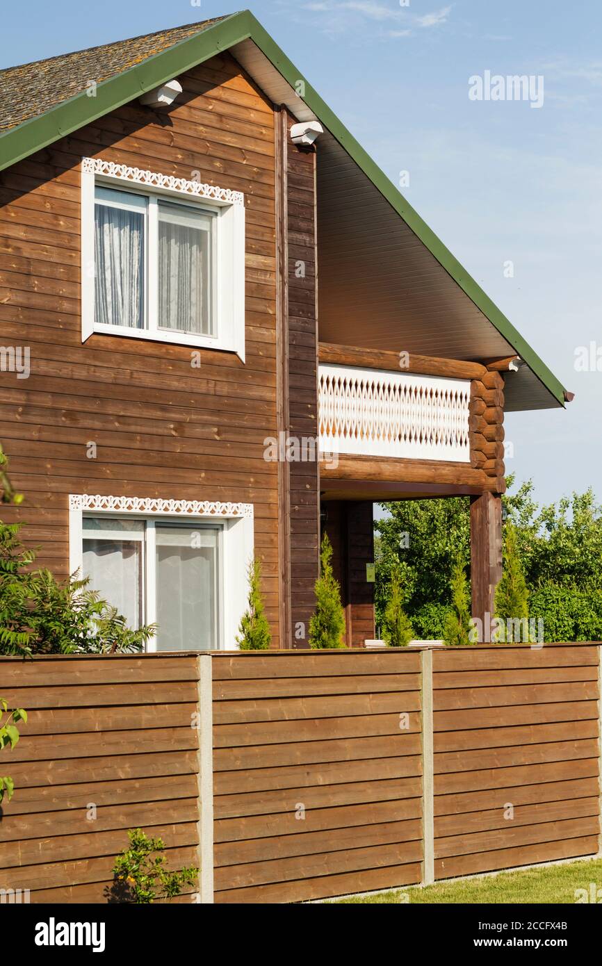 wooden house, green grass and a blue sky Stock Photo