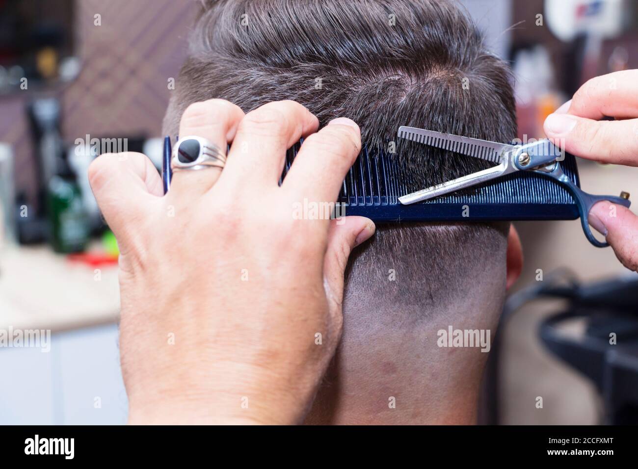 men's hair Styling and grooming with the help of scissors machine and hair  clippers in the hair salon Stock Photo - Alamy