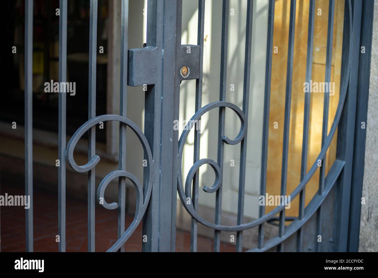 detail of a wrought iron gate for shop placed outside Stock Photo Alamy