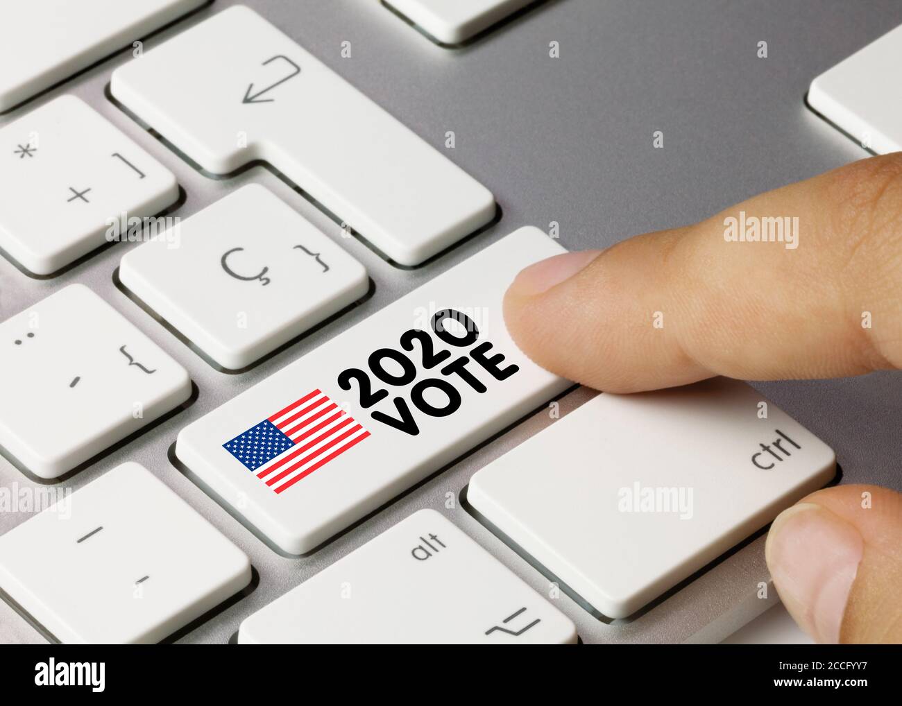EEUU 2020 VOTE Written on White Key of Metallic Keyboard. Finger pressing key. Stock Photo