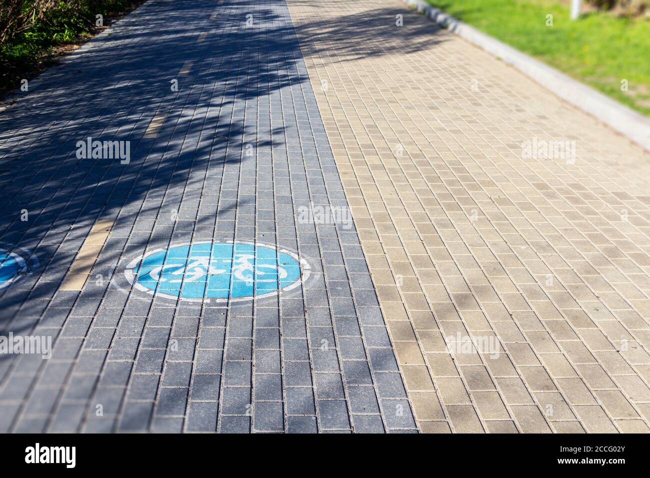 sign Bicycle path on the paving slabs in the Park Stock Photo