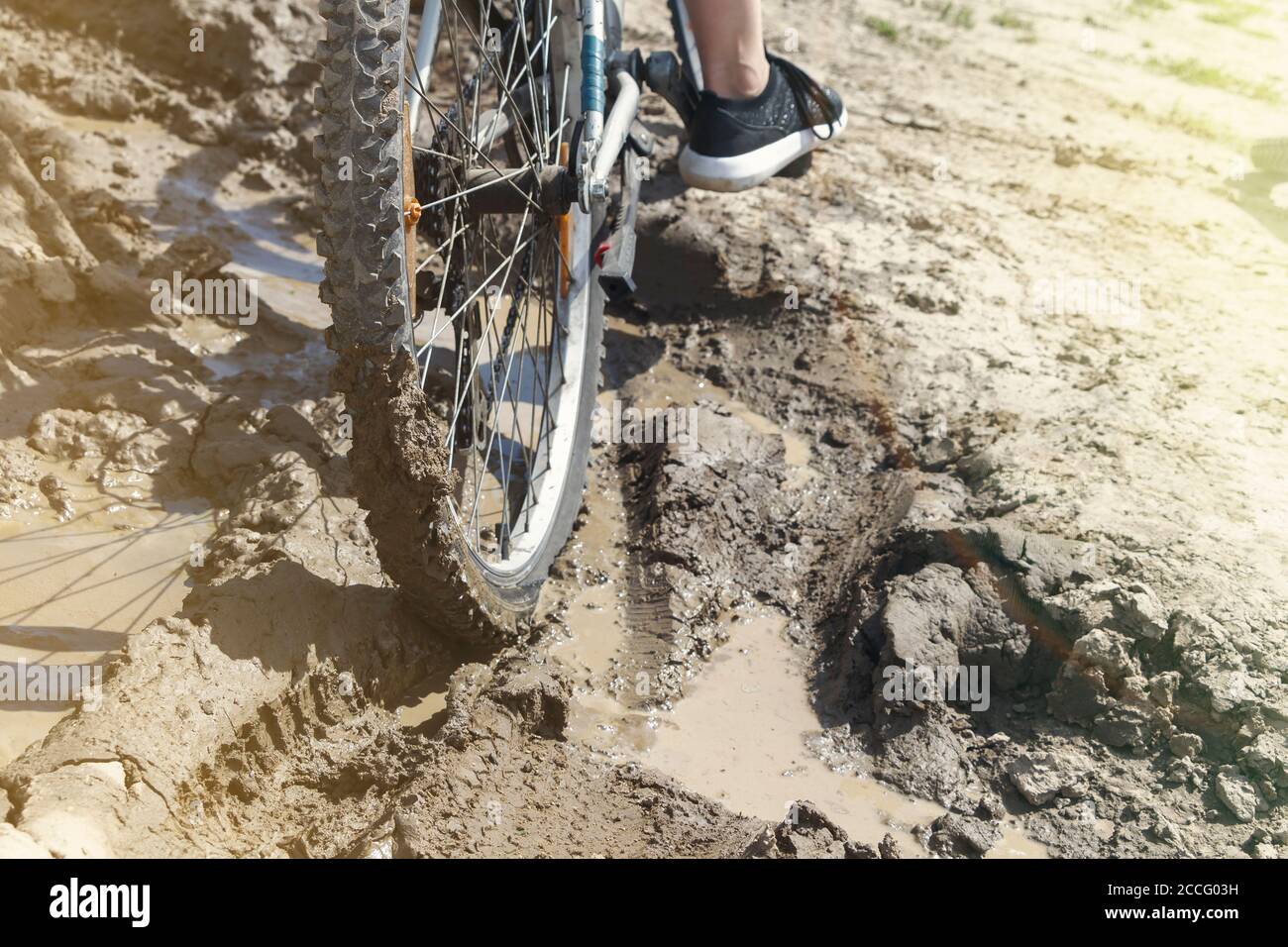 the Bicycle wheel is stuck in the mud. Close up Stock Photo Alamy