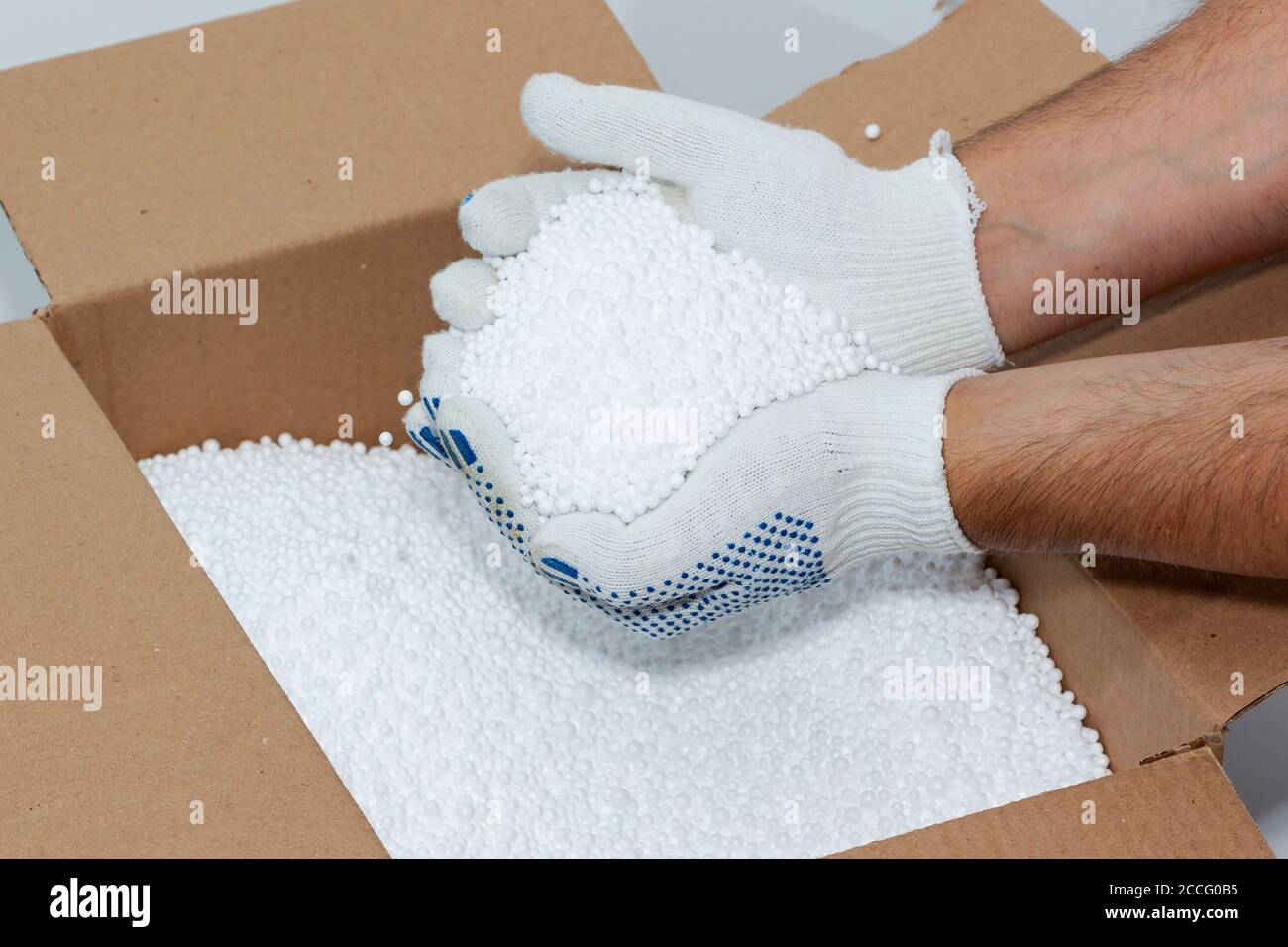 Round Styrofoam balls in my hands, the texture for the background. Environmental protection Stock Photo
