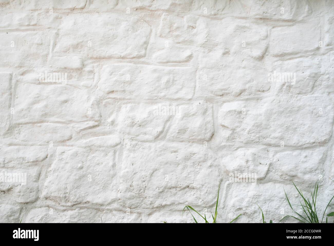 Detail and texture of whitewashed stone all. Ancient construction is sturdy and strong. Natural light with copy space Stock Photo