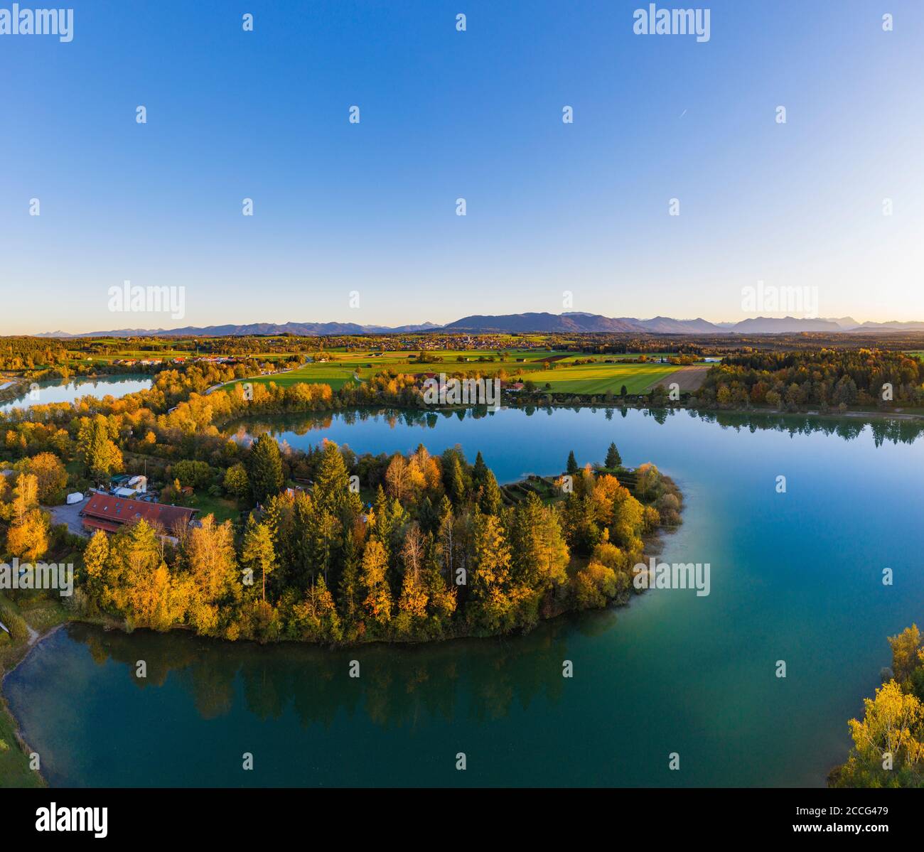 Baggersee in the evening light, Bibisee, in the back Königsdorf, Tölzer Land, aerial view, Upper Bavaria, Bavaria, Germany Stock Photo