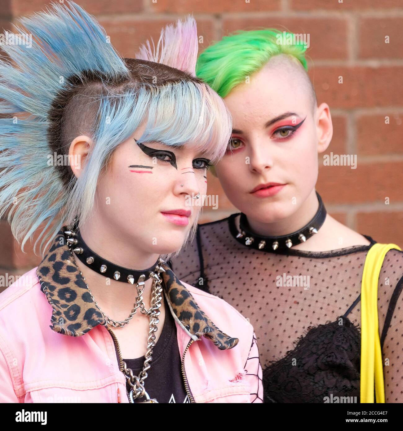 2 beautiful punk girls with studded collars, vivid hair styles and dramatic makeup Stock Photo