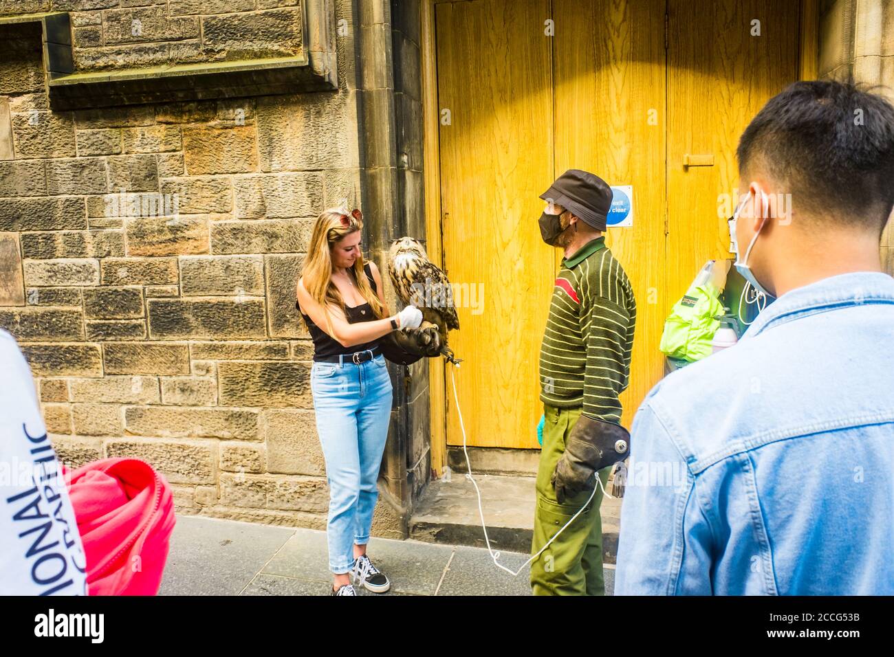 Edinburgh Scotland 6th Aug 2020 young woman holding eagle owl on Royal Mile Stock Photo