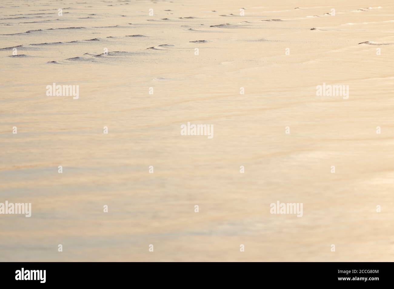 Europe, Germany, Lower Saxony, Otterndorf. Tender evening light on the flat waves of the running water. Stock Photo