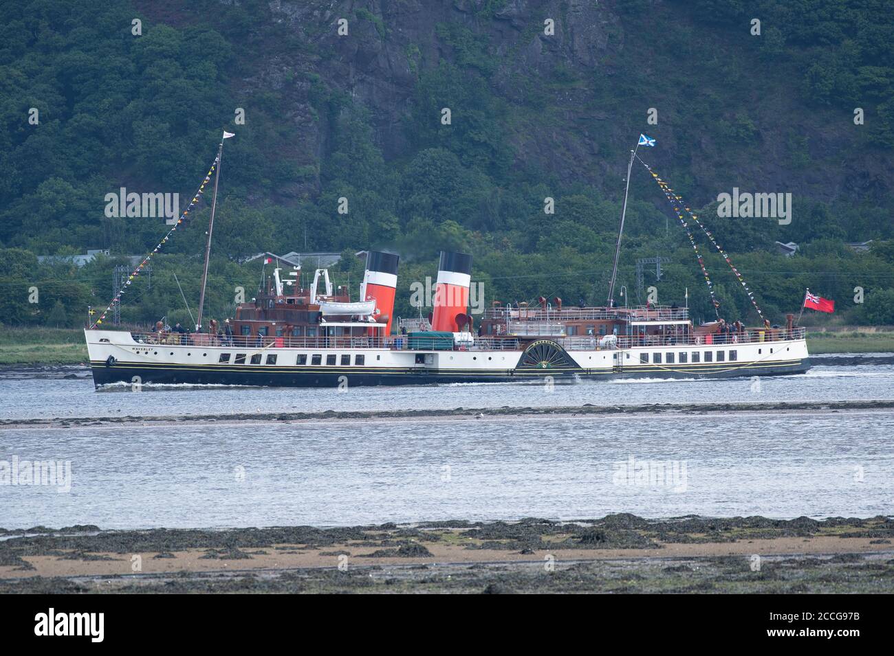 Langbank, Scotland, UK. 22nd Aug, 2020. The world's oldest working paddle steamer The Waverley sails down the Clyde near Dumbarton with its first paying passengers, making her triumphant return after being out of service for 22 month following her extensive boiler refit. Built over 70 years ago, the PS Waverley is the world's last sea-going paddle steamer. The Waverley will operate until Sunday 6th September on the Clyde. Credit: Antonio Brecht Grist/Alamy Live News Stock Photo