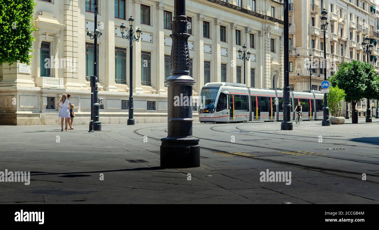 Selective focus on the tramway with blurry pedestrians. Stock Photo