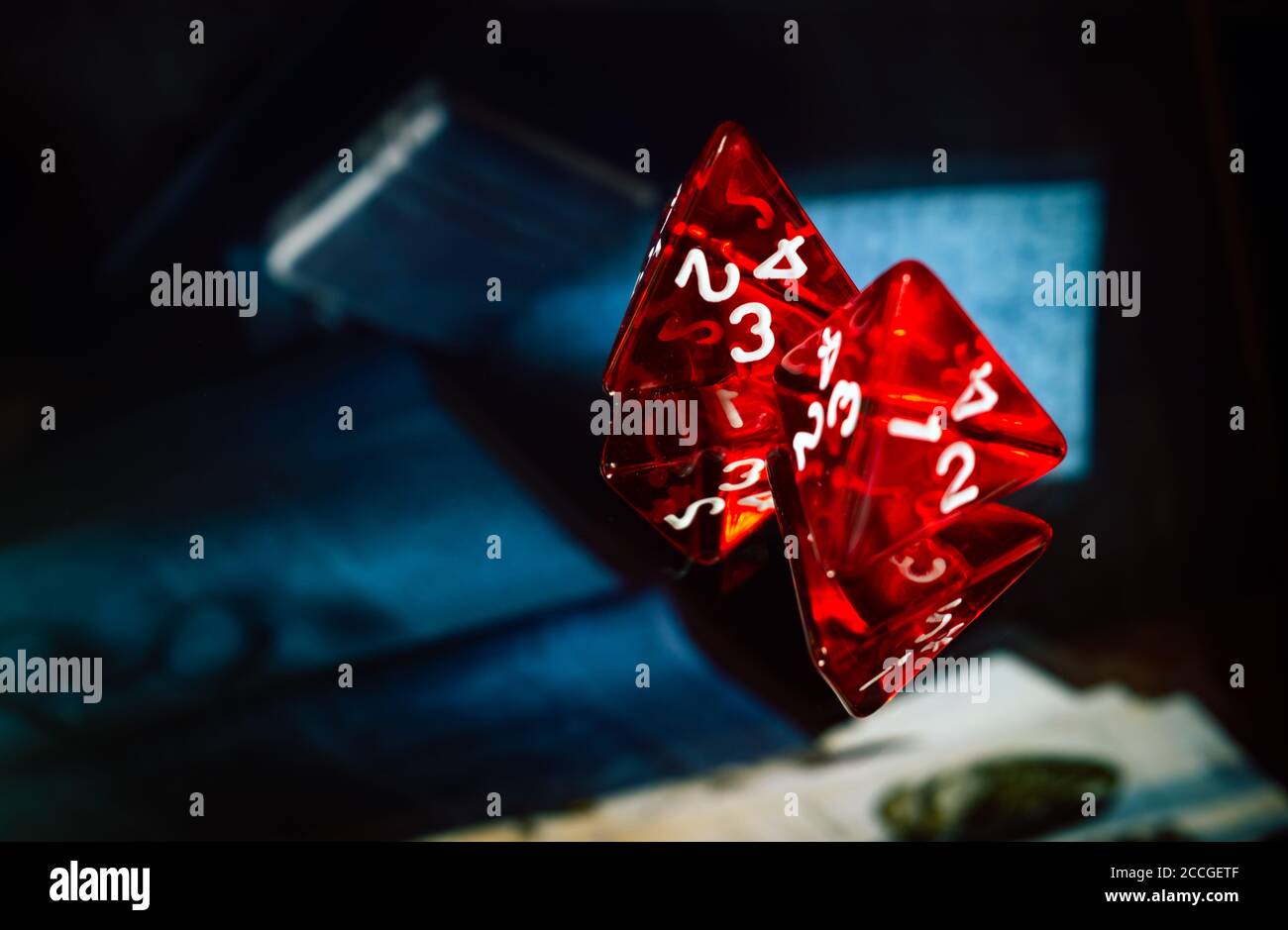 Close up of two transparent pyramid dice,2d4, on a reflective surface Stock Photo