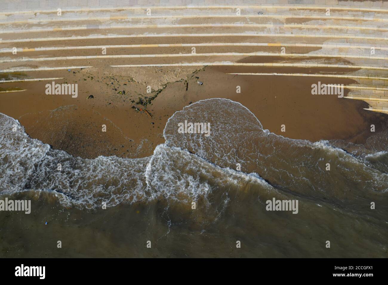 Water waves corroding stone steps, top view Stock Photo
