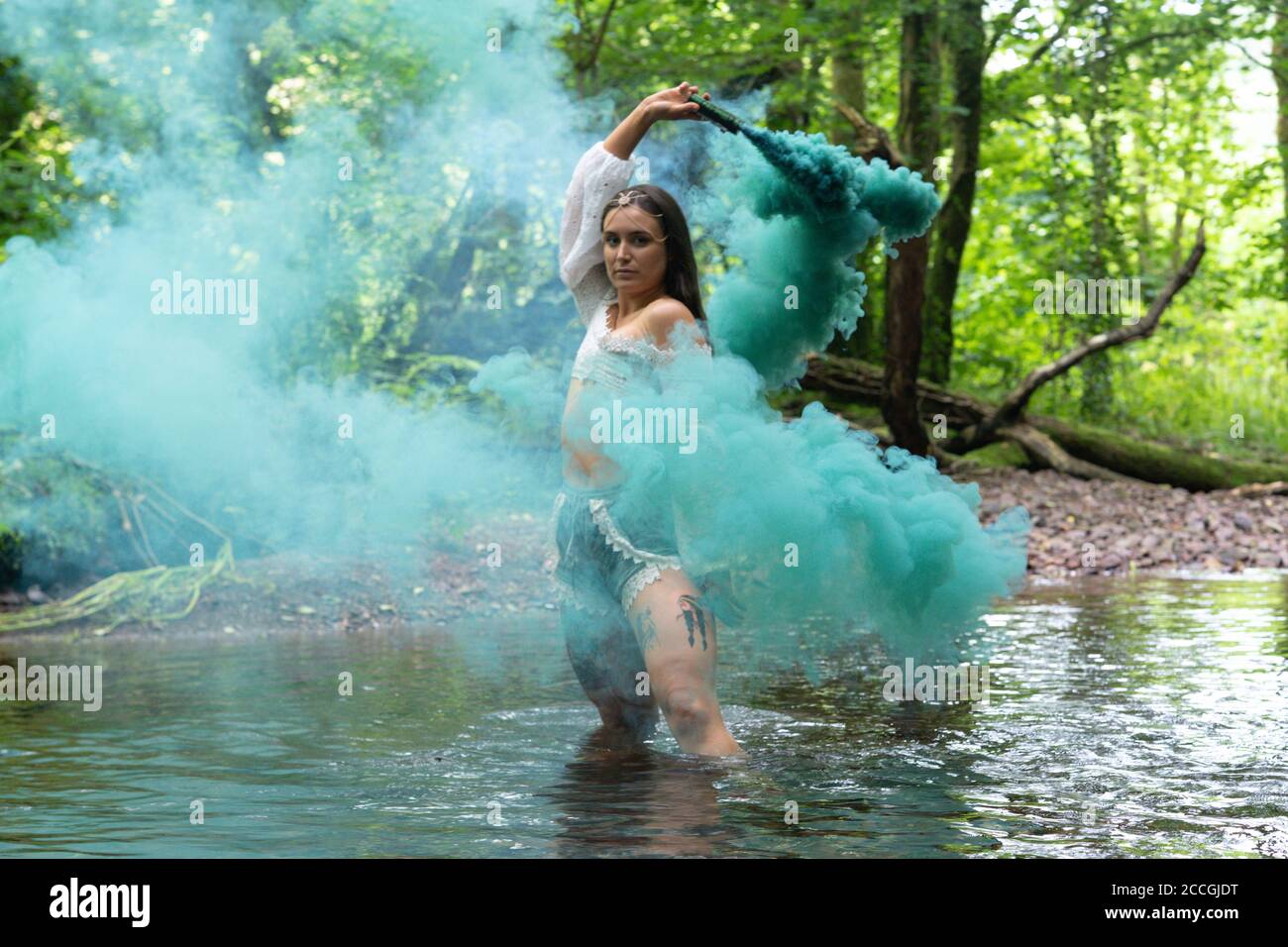 Irish girl using smoke bomb in a forest Stock Photo Alamy
