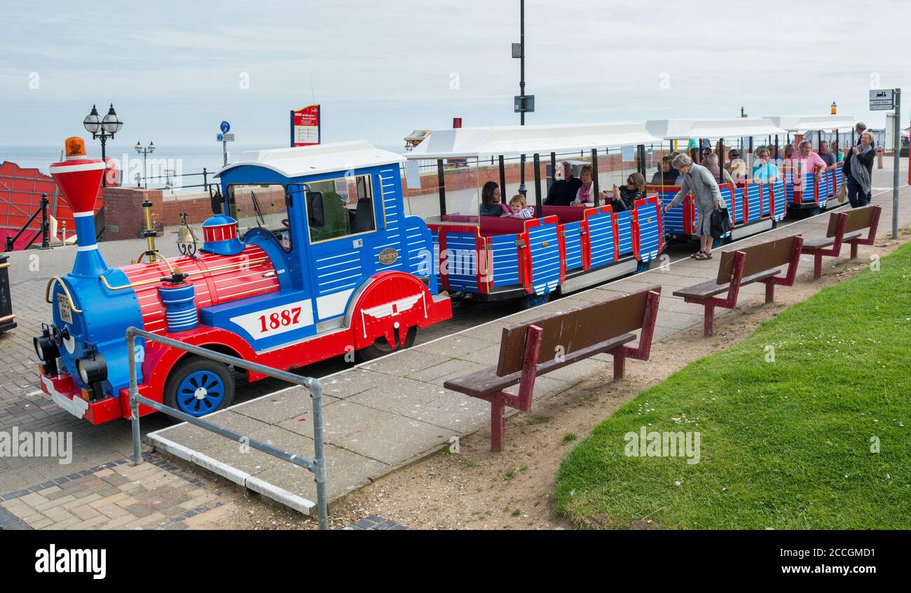 Visitors boarding the land train on the promenade at Bridlington in