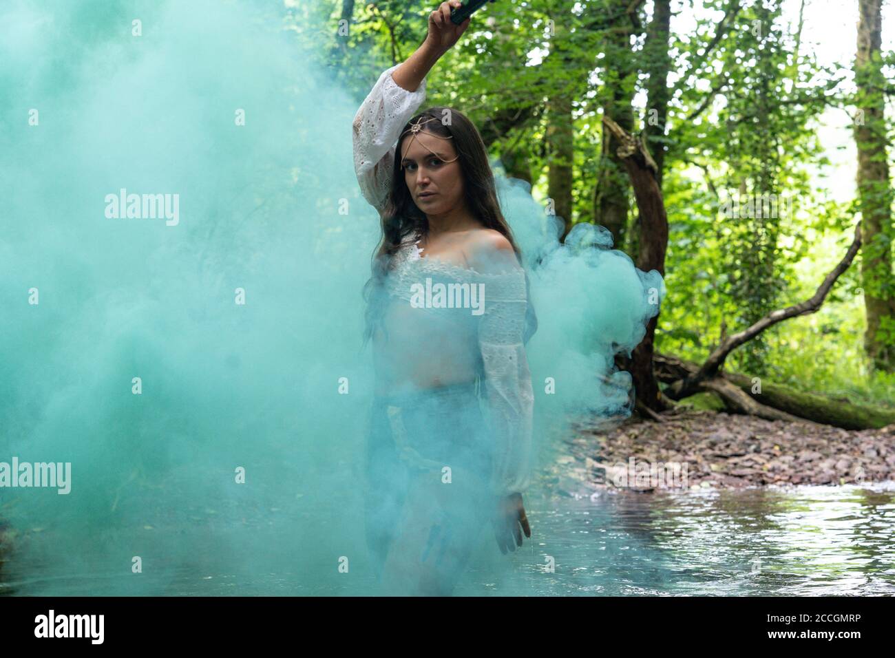 Irish girl using smoke bomb in a forest Stock Photo Alamy