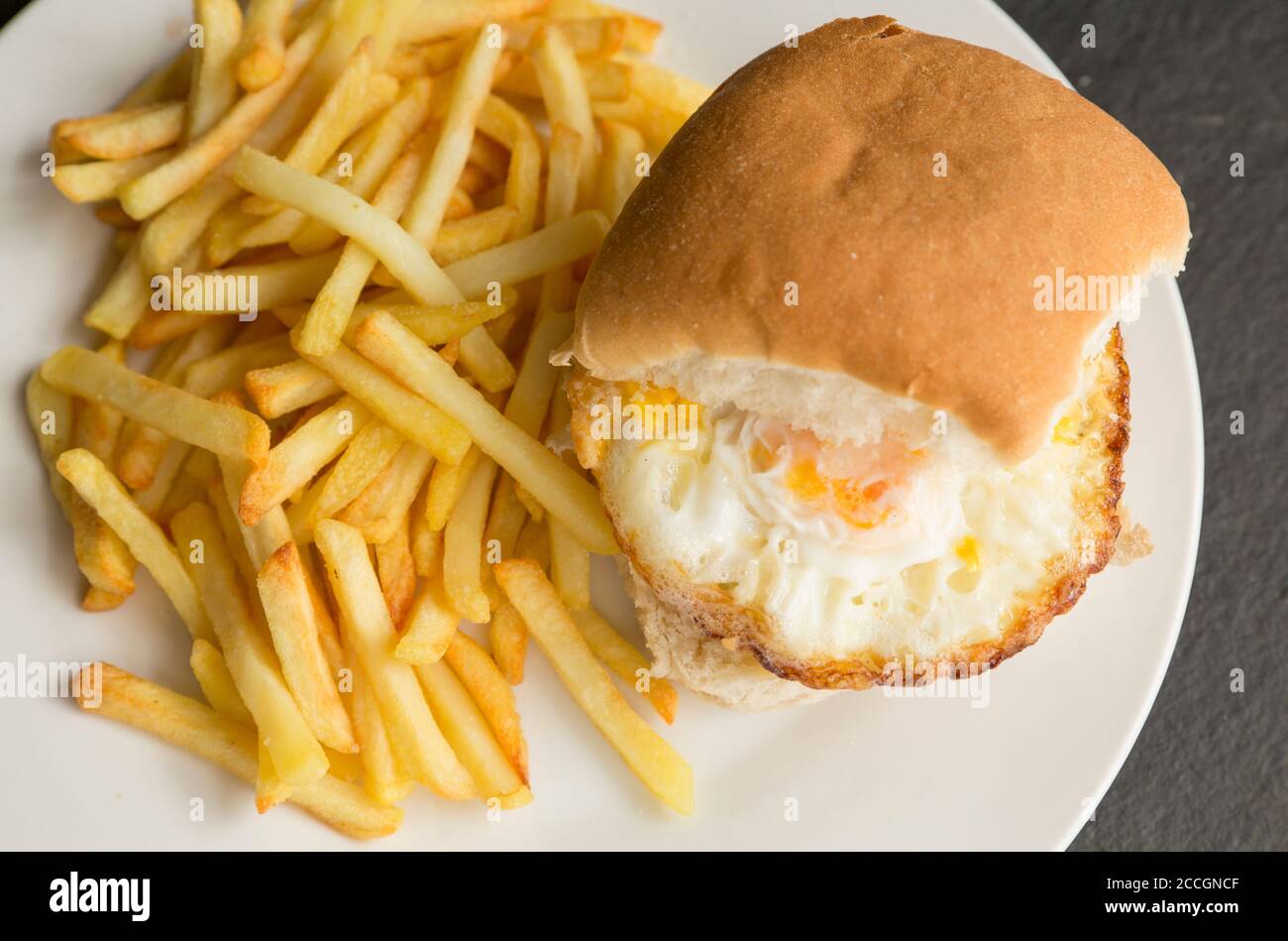 Two fried eggs in a bun with oven chips. England UK GB Stock Photo Alamy