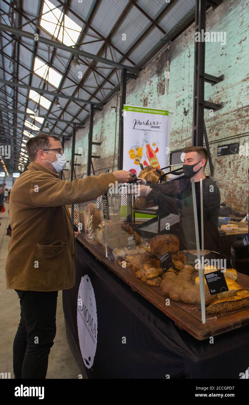 Sydney, Australia. 22nd Aug, 2020. People shop at Carriageworks Farmers Market in Sydney, Australia, on Aug. 22, 2020. Carriageworks was built between 1880 and 1889 as part of the Eveleigh Railway Workshops. In 2007, the site was redeveloped as a cultural precinct. Today, Carriageworks is a significant multi-arts center in Australia. Credit: Hu Jingchen/Xinhua/Alamy Live News Stock Photo
