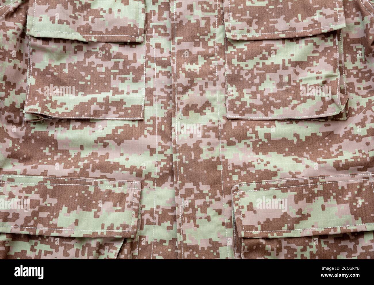 US army acu digital desert uniform shirt background, texture Military camouflage fabric textile closeup view, pocket detail Stock Photo