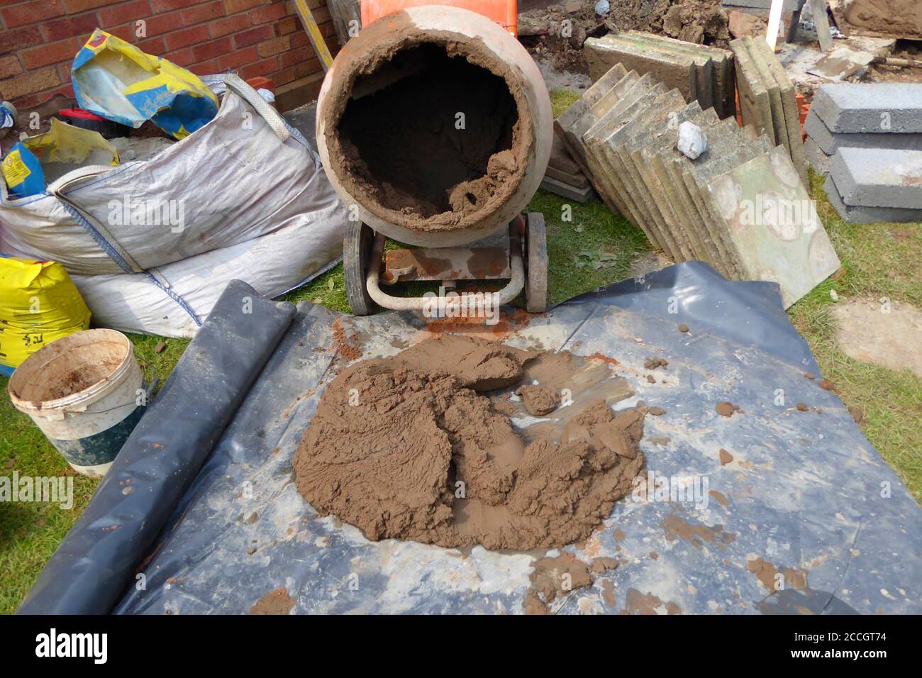 close up of concrete mixer and slabs with mortar for conservatory base
