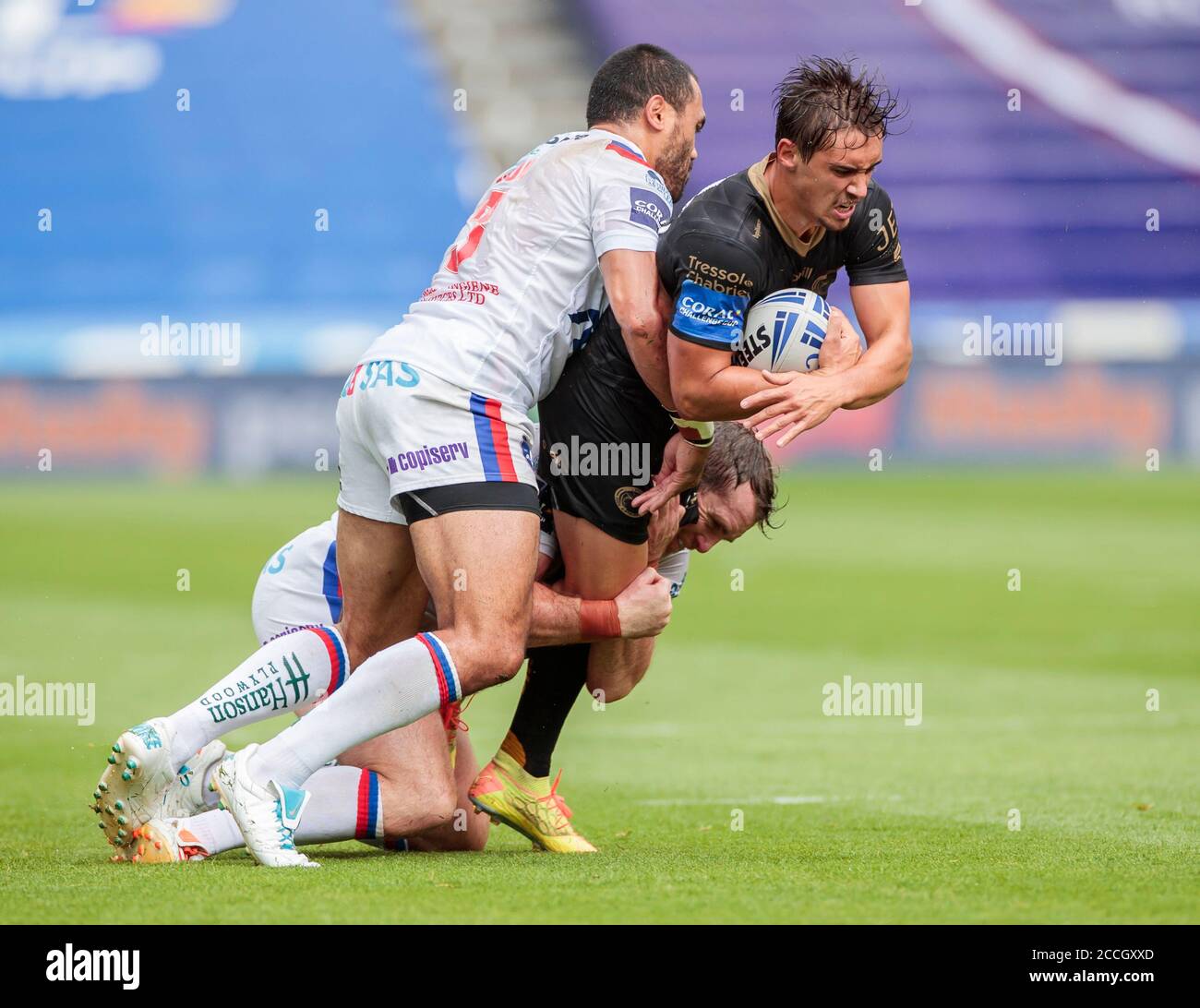 Catalan Dragon's Arthur Mourgue (centre) is tackled by Wakefield Trinity's Pio Tupou (front) and Matthew Ashurst during the Betfred Super League match at The John Smith's Stadium, Huddersfiel Stock Photo