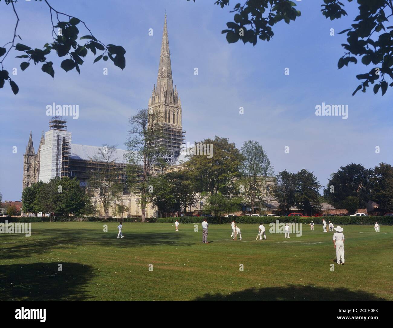 Boys cricket match being played within sight of Salisbury Cathedral, Wiltshire, England, UK. Circa 1990's Stock Photo