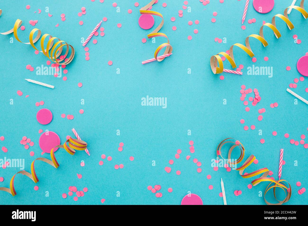 Top view of confetti on a blue background with space for text in the ...