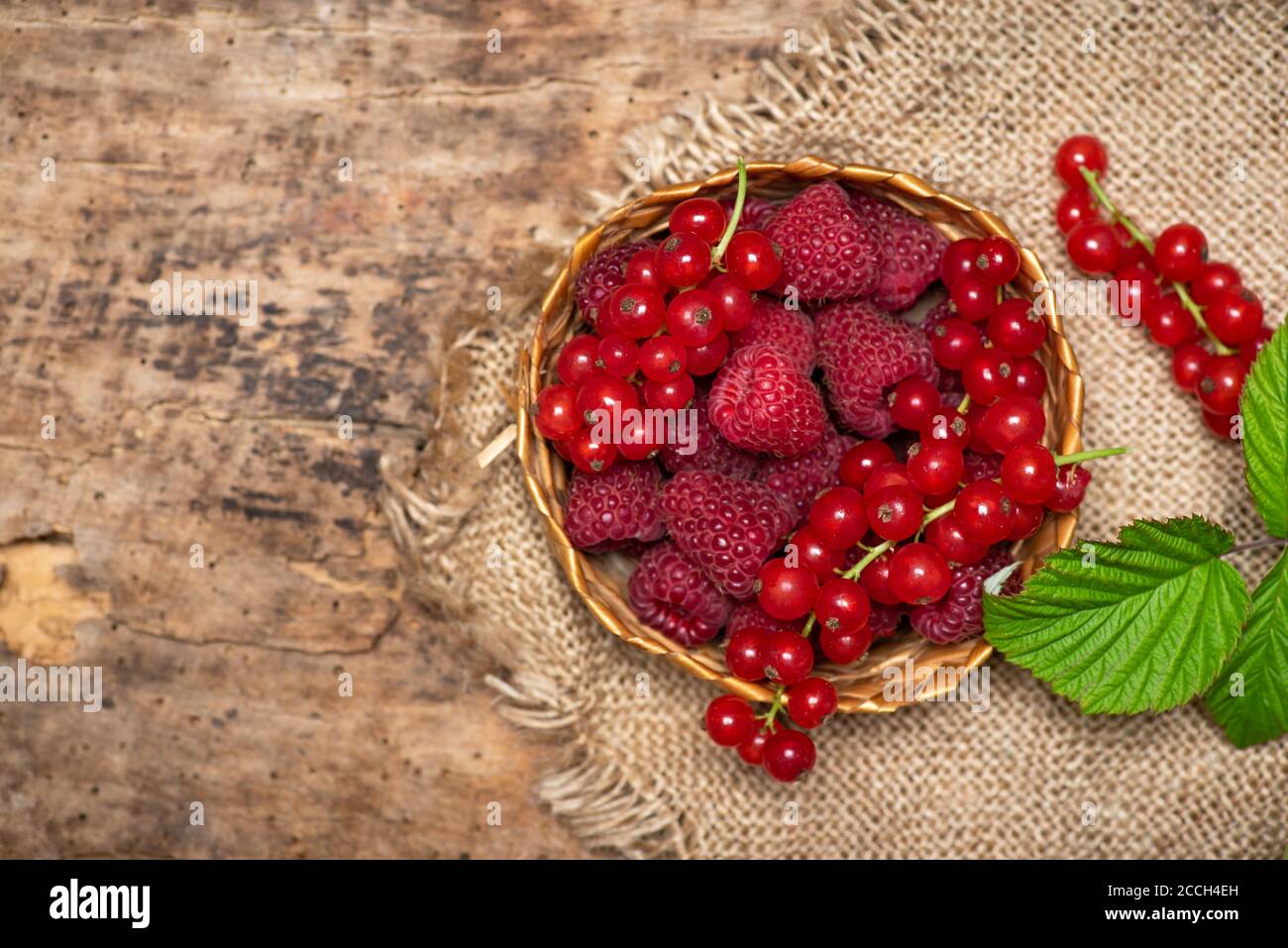 fresh raspberry and currant red berry fruits in a bowl top view Stock Photo